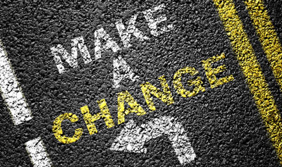 Words "Make a change" stenciled on pavement with arrow