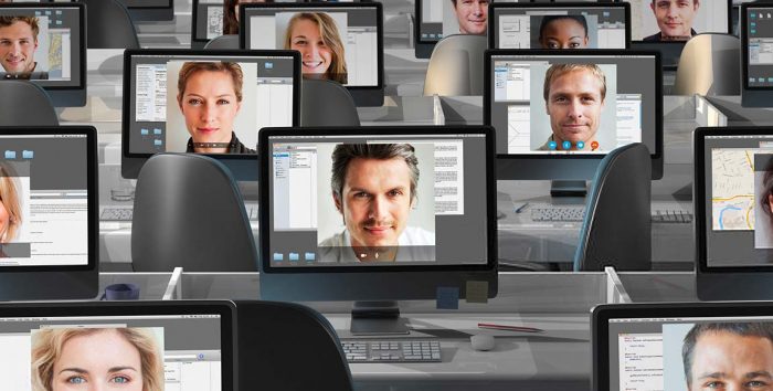 12 Computer Screens with Faces of remote works on each one