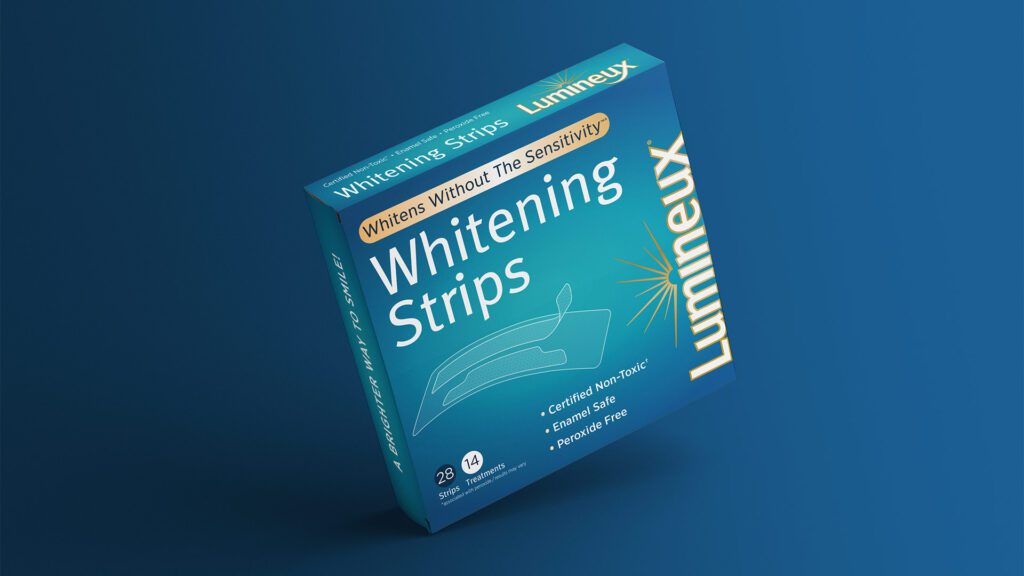 Image of a box labeled "Lumineux Whitening Strips." The packaging highlights features such as "Whitens Without The Sensitivity," "Certified Non-Toxic," "Enamel Safe," and "Peroxide Free." The box contains 28 strips for 14 treatments.