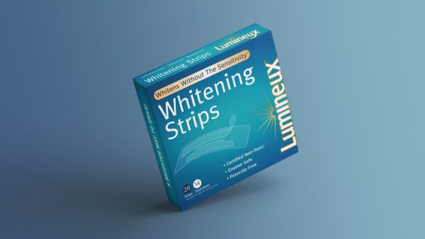 A teal box of Lumineux Whitening Strips is displayed. The packaging highlights features like "Whitens Without The Sensitivity" and indicates 28 strips for 14 treatments. The product is described as "Certified Non-Toxic, Enamel Safe, Preservative Free.